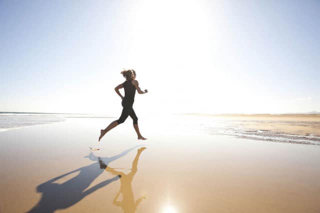 Woman Running on Beach